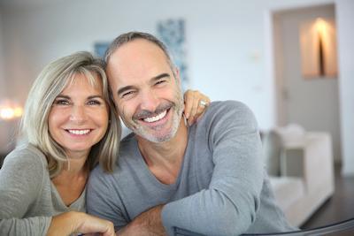 smiling couple in living room | Dentist Fontana CA