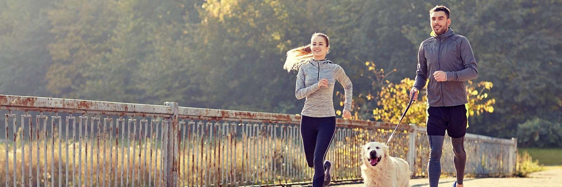 Couple jogging with their dog