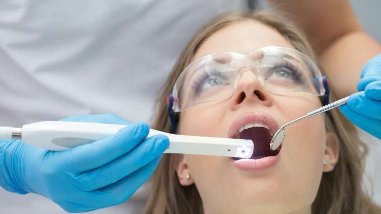 Woman in dental chair getting dental implants, Fontana CA